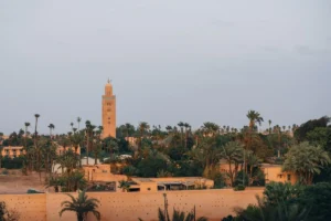 Moroccan minaret tower surrounded by palm trees