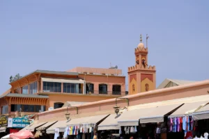 Market stalls with a minaret in the background.