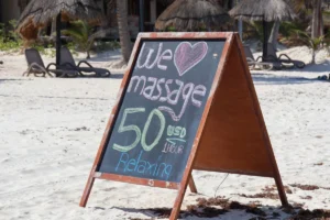 a sign on the beach that says we love massage