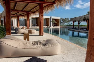 Me and my girlfriend visited Olea All Suites Hotel at Zakynthos, Greece. An amazing piece of architecture that combines nature and modernism to make a peaceful and luxurious vacation. Shot taken from a sofa by the pool, with a cup of Ouzo on the rocks. YES!