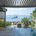 brown wooden chairs near swimming pool during daytime